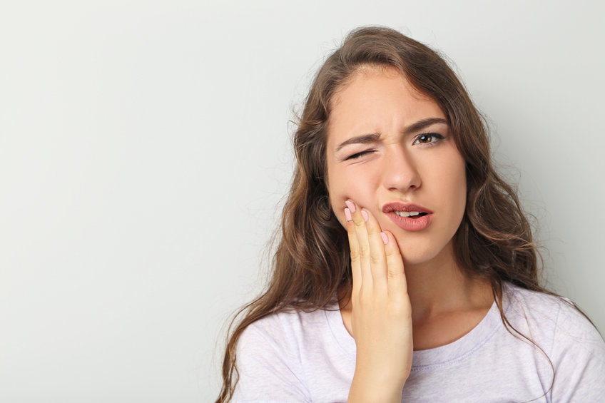 Young woman have a toothache